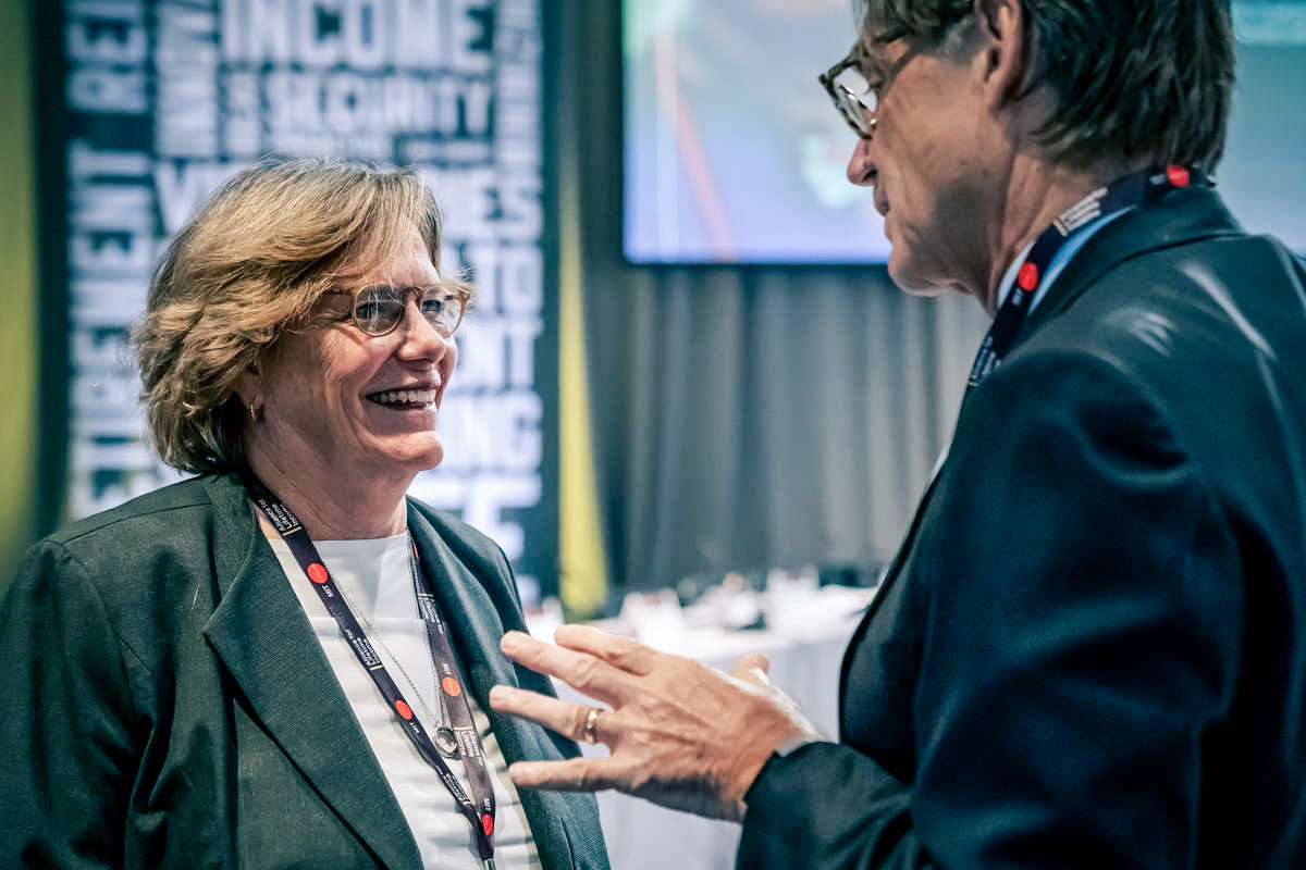 Woman smiling and talking with a man.